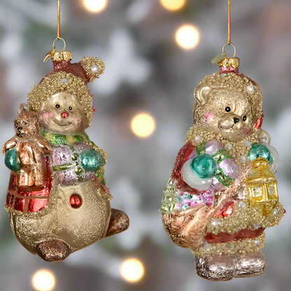 Two glittery Christmas ornaments, one resembling a snowman and the other a bear, on a white background.