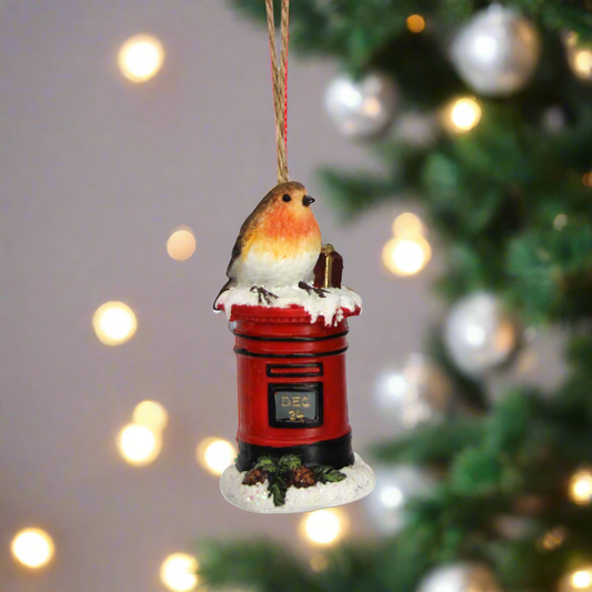 Two decorative Christmas ornaments featuring birds on red telephone boxes against a white background.