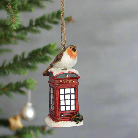 Two decorative Christmas ornaments featuring birds on red telephone boxes against a white background.