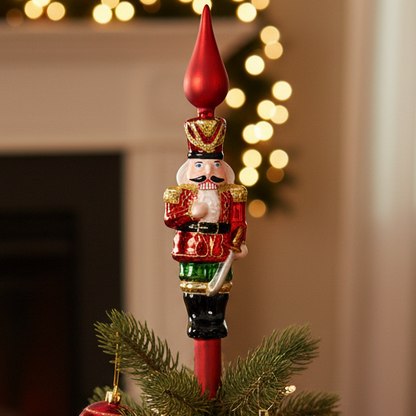 Decorated Christmas tree with ornaments and a Nutcracker topper in a festive living room.