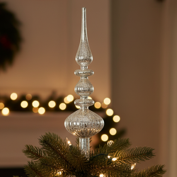Decorated Christmas tree with a crystal topper in a festive living room.