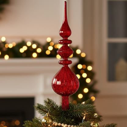 Decorated Christmas tree with red and gold ornaments in a festive room setting.