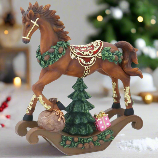 Decorative rocking horse figurine with Christmas elements on a white background