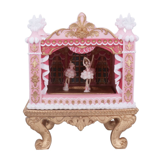 Decorative pink and gold cabinet with ballerina figurines on a white background