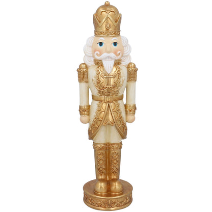 Decorative nutcracker figure with gold and white attire on a white background