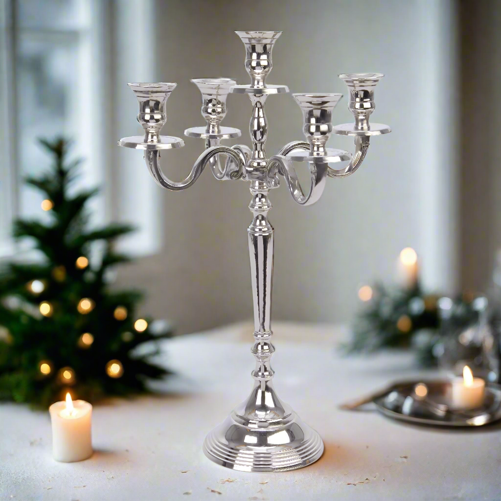 A silver candelabra with five candle holders, featuring a decorative base and a classic design.