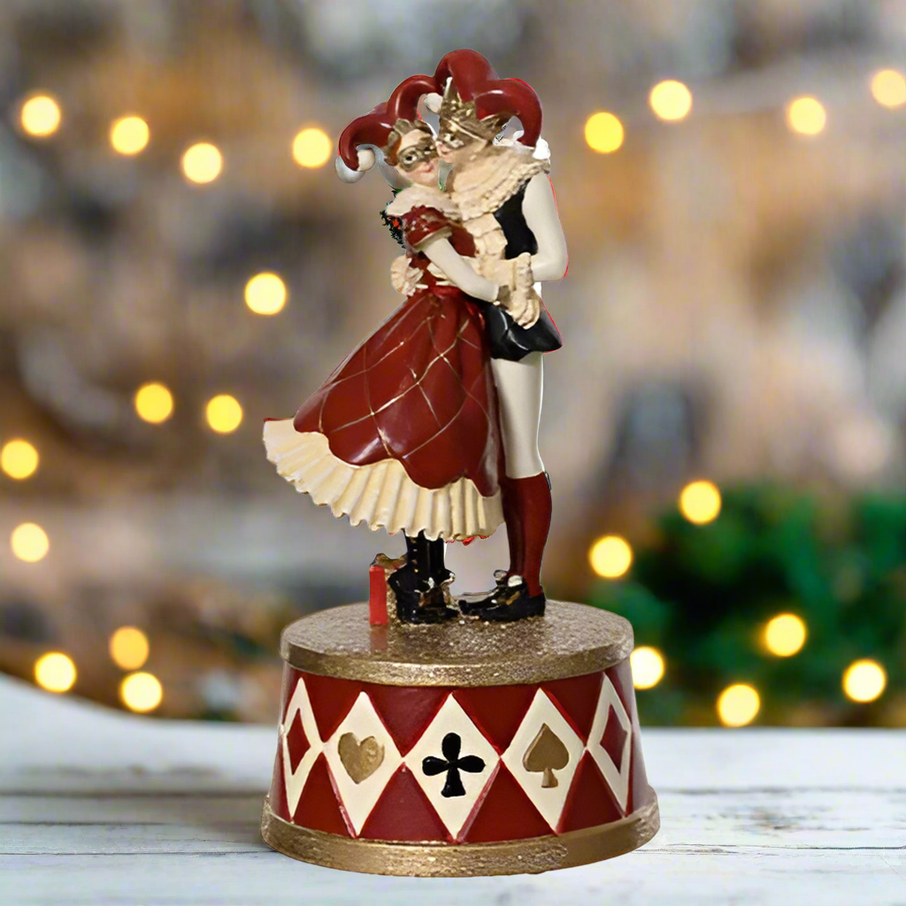 Statue of a jester character on a white background