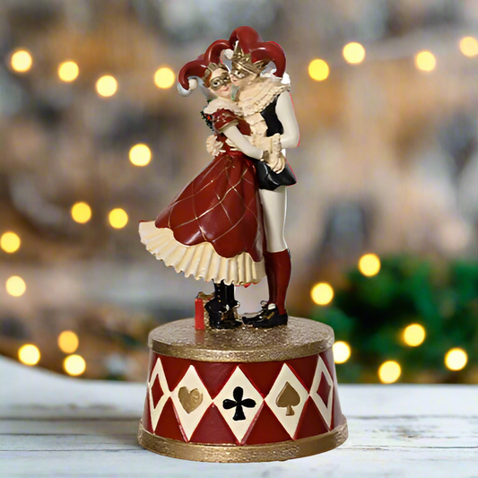 Statue of a jester character on a white background