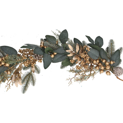 Decorative garland with green leaves and gold berries on a white background