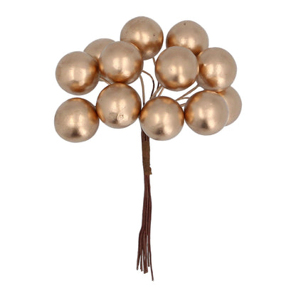 A bunch of matt gold berry pick decorations with visible stems, against a white background.