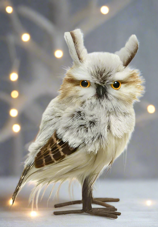 A plush toy owl with gray and beige feathers, perched on a branch-like structure, designed as a Christmas decoration.