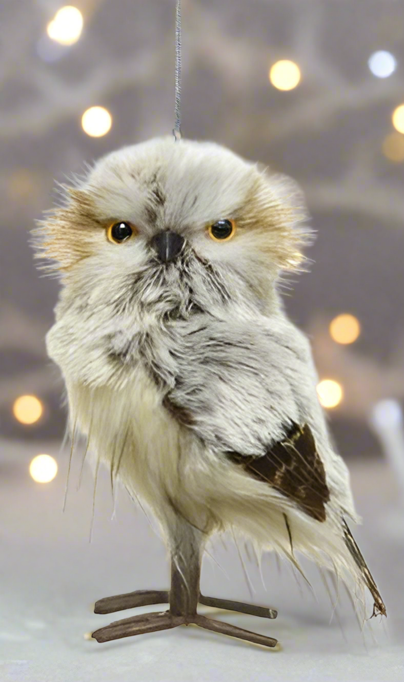 A Tawny Owl Christmas decoration featuring an owl with a fluffy white and brown body perched on a small wooden stand.