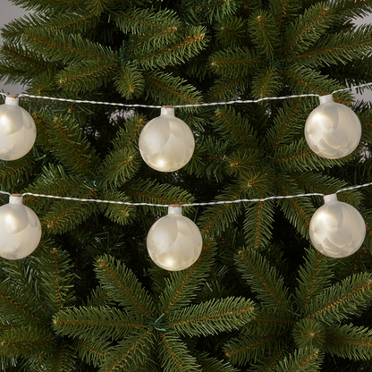 A string of frosted ball-shaped LED lights with a warm white finish, connected by silver cables.