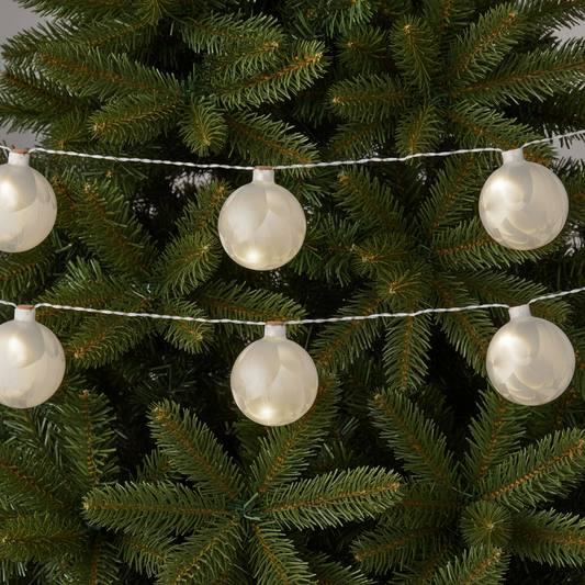 A string of frosted ball-shaped LED lights with a warm white finish, connected by silver cables.