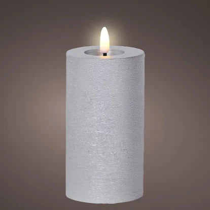 A silver-colored LED wax candle with a flat top and a warm white flame, designed for indoor use.