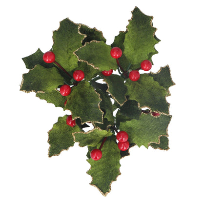 A green velvet candle ring with holly leaves and red berries around its circumference.