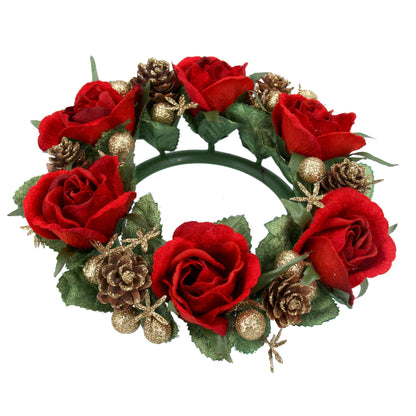 A circular candle ring adorned with red roses, pine cones, and golden berries designed for Christmas decoration.