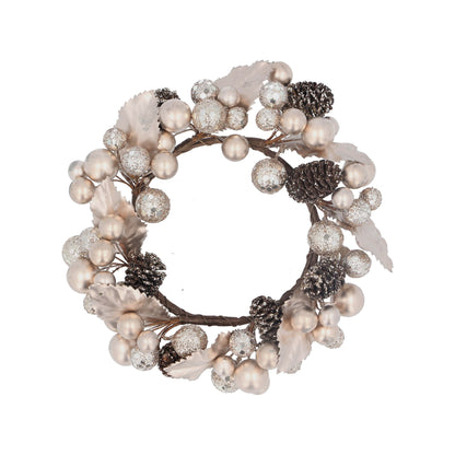 A round, pale gold candle ring with berry and pinecone decorations.