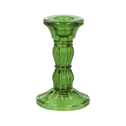 A green glass Christmas candlestick with a vintage design, featuring a narrow top and a wider base, standing against a white background.