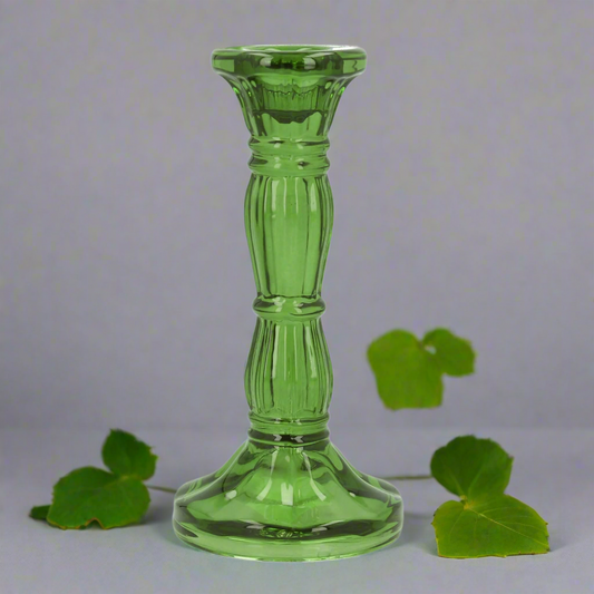 Green glass candle holder on a white background