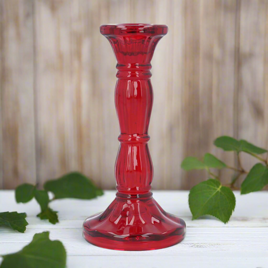 Red glass candle holder on a white background