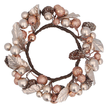 A decorative candle ring featuring pale gold and copper berries, leaves, and pine cones, designed to be wrapped around a candle.