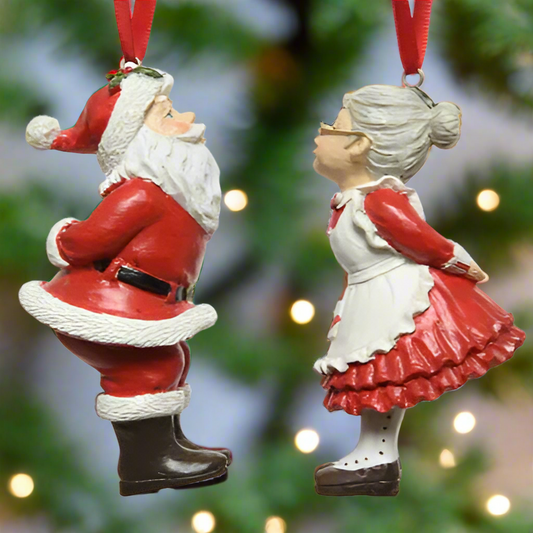 Decorative Christmas ornaments of a Santa Claus and Mrs. Claus on a white background