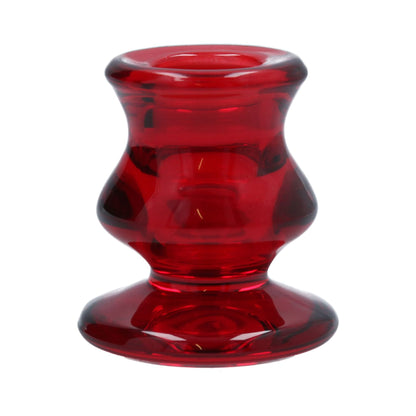 A red glass Christmas candlestick with a conical shape and a rounded base.