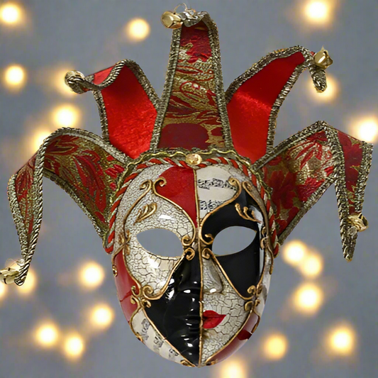 Decorative mask with red, gold, black, and white colors on a blurred light background