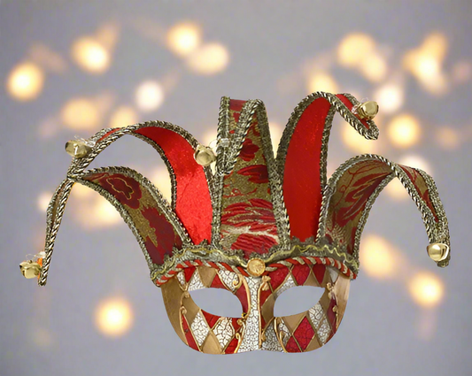 Decorative red and gold jester hat against a blurred light background