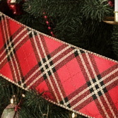 Red ribbon with black and gold plaid pattern on a white background