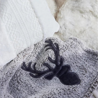 Gray textured blanket with a black deer head design on a white background