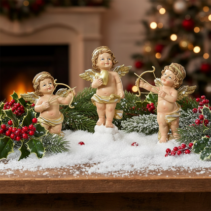 Three angel figurines with wings and bows on a white background