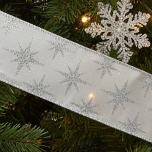 A roll of silver and white glittery Christmas ribbon with a star pattern, 5 meters in length.