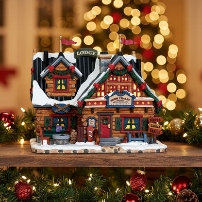 Decorative model of a mountain lodge with snow and flags on a white background