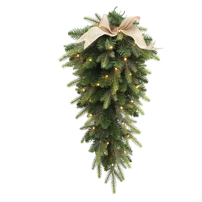 Decorative Christmas swag with lights and a bow on a white background