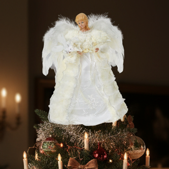 A white angel tree topper with feather wings and a white dress, holding a small white basket, designed to be placed on top of a Christmas tree.