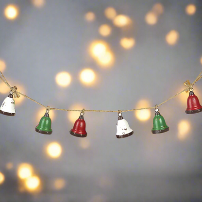 A garland of red, white, and green Christmas bells with a rustic jute hanging rope.