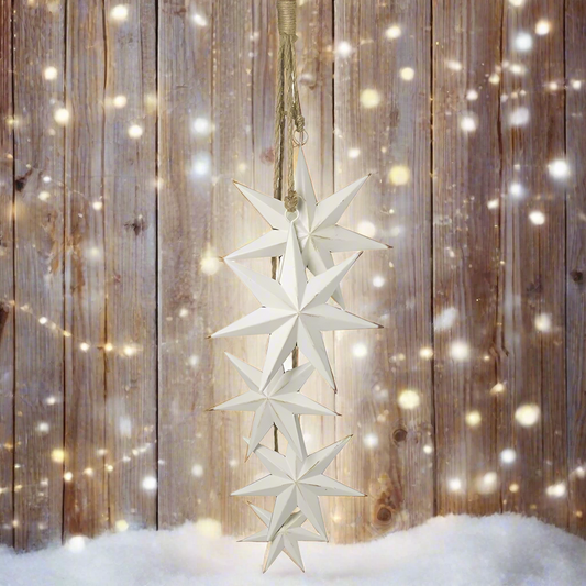 A hanging decoration featuring five white metal stars of different sizes, attached to a jute rope.