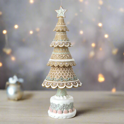 A decorative gingerbread Christmas tree with multiple layers, featuring beige, white, and multicolor patterns, topped with a star, on a white base.