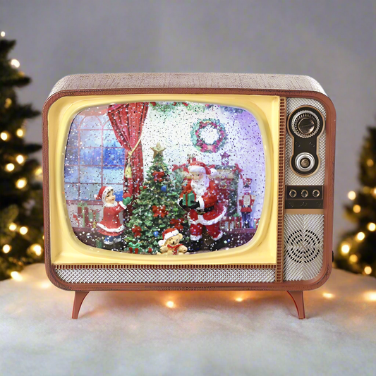 A decorative item resembling a vintage television with a Christmas scene featuring Santa Claus inside the TV screen. It appears to be a water spinner as there is a mist or vapor coming out from the bottom.