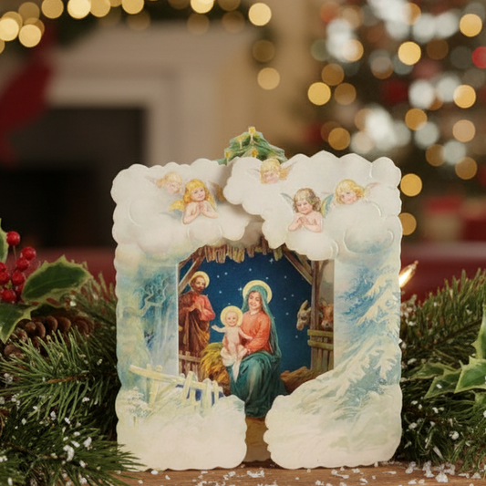 A Christmas card with a Victorian-inspired illustration of the nativity scene, featuring die-cut shapes and embossed details, left blank for personal message.