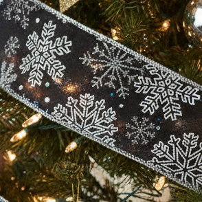 A length of dark blue Christmas ribbon with a silver snowflake pattern, 2.7m in length.