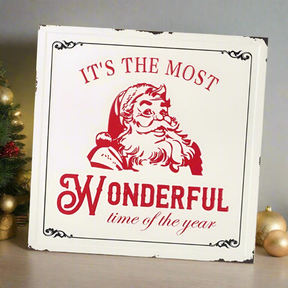 Vintage style metal sign with a red Santa face with the wording "it's the most wonderful time of the year.