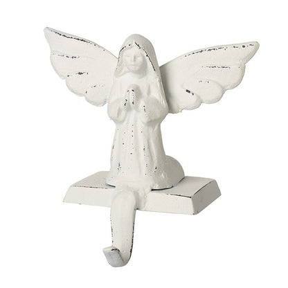 White angel stocking hanger made of cast iron, featuring an angelic figure with outstretched wings in a praying posture, mounted on a base.