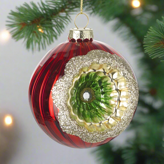 A red glass ornate bauble with gold hanging wire and green and silver decorative details.