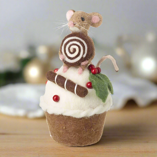 A felt ornament featuring a mouse sitting on a cupcake with a swirl decoration and red berries, with a green leaf accent.