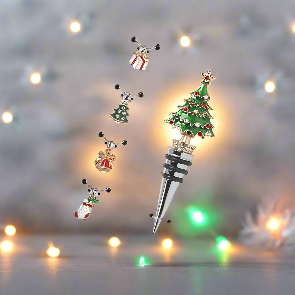 A set of wine glass charms and a Christmas tree bottle stopper, presented in a box with a festive design.