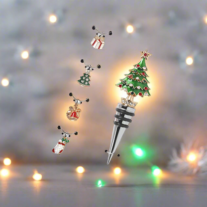 A set of wine glass charms and a Christmas tree bottle stopper, presented in a box with a festive design.