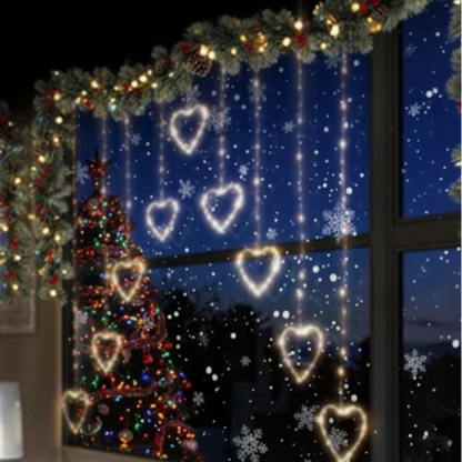Heart-shaped Christmas curtain lights in a warm white color, installed on a window, creating a cozy ambient lighting effect.